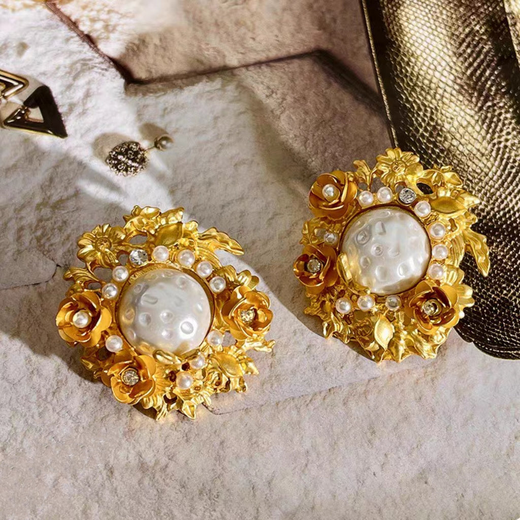 Flowers surround pearl earrings