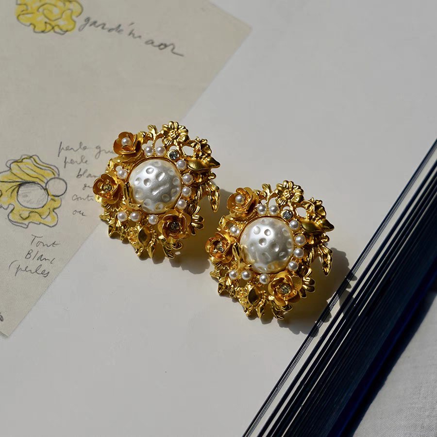 Flowers surround pearl earrings