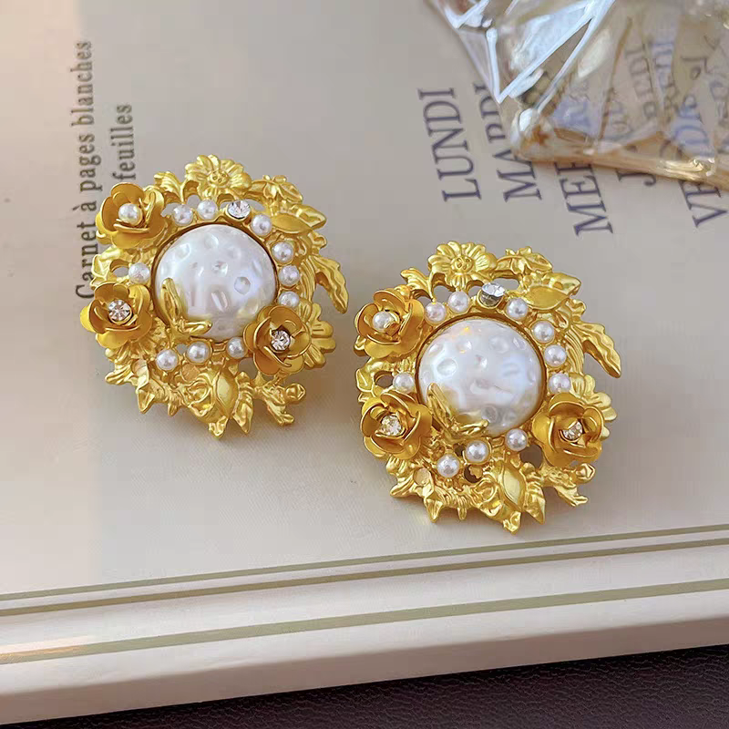 Flowers surround pearl earrings