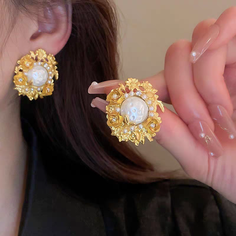 Flowers surround pearl earrings