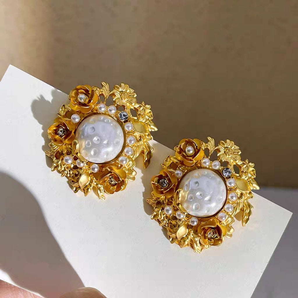 Flowers surround pearl earrings